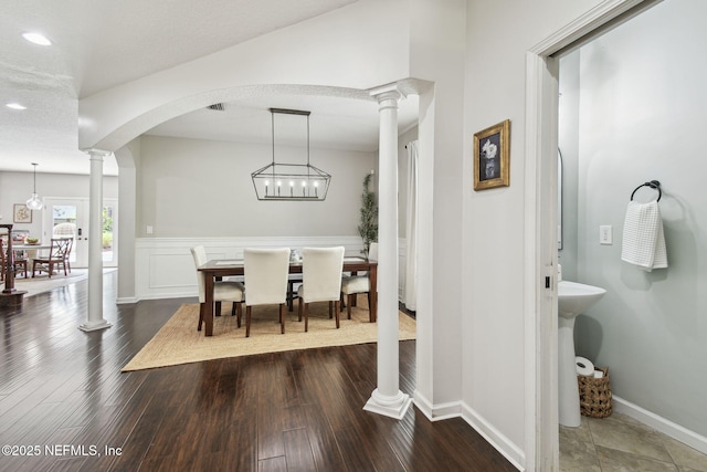 1083 Three Forks Ct, Saint Augustine, FL 32092 - dining space with decorative columns, arched walkways, recessed lighting, and dark wood-style flooring