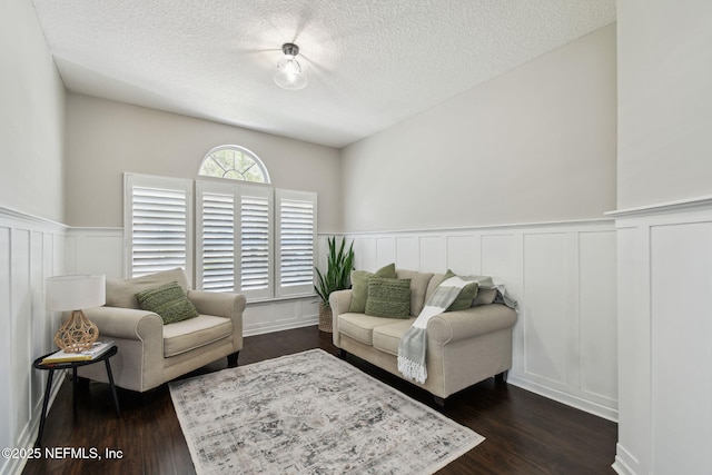 1083 Three Forks Ct, Saint Augustine, FL 32092 - living room with a textured ceiling, a wainscoted wall, dark wood-type flooring, and a decorative wall