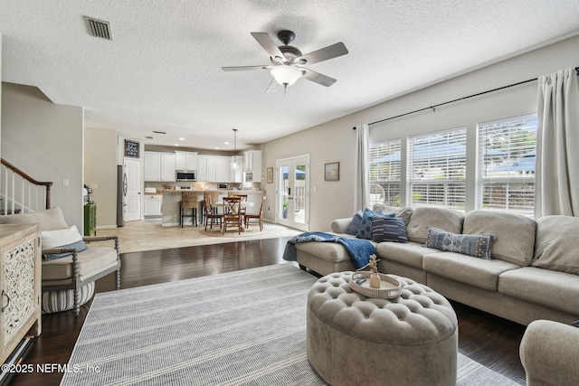 1083 Three Forks Ct, Saint Augustine, FL 32092 - living area with a ceiling fan, wood finished floors, a textured ceiling, stairway, and french doors