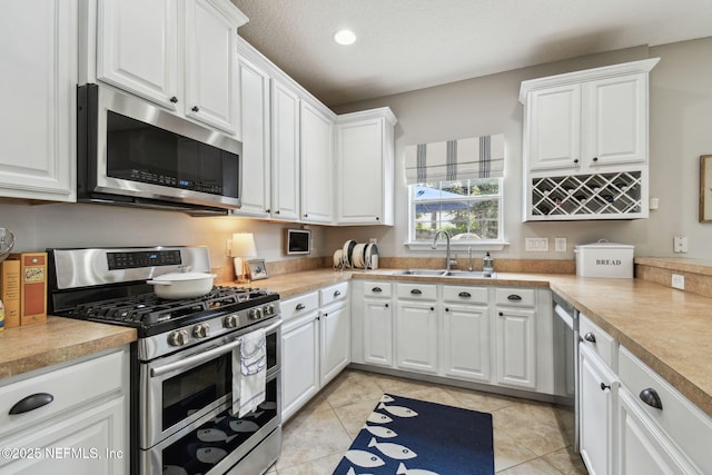 1083 Three Forks Ct, Saint Augustine, FL 32092 - kitchen featuring stainless steel appliances, white cabinets, light countertops, light tile patterned floors, and recessed lighting