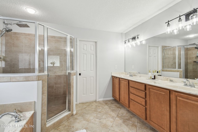 1083 Three Forks Ct, Saint Augustine, FL 32092 - full bathroom featuring a textured ceiling, a shower stall, double vanity, a garden tub, and tile patterned flooring