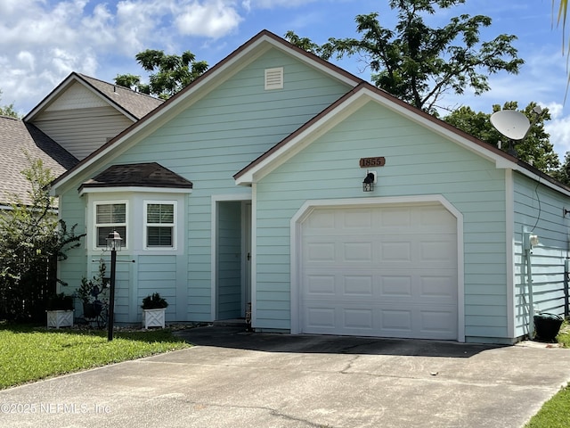 1855 N Alberta Ct, Middleburg, FL 32068 - view of front of home featuring concrete driveway, a garage, and a shingled roof
