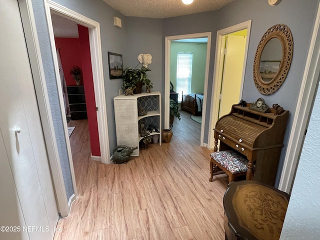 1855 N Alberta Ct, Middleburg, FL 32068 - corridor featuring light wood-type flooring and a textured ceiling
