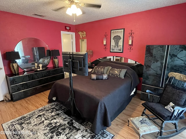 1855 N Alberta Ct, Middleburg, FL 32068 - bedroom featuring wood finished floors, a textured ceiling, and ceiling fan