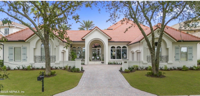 112 Harbourmaster Ct, Ponte Vedra Beach, FL 32082 - mediterranean / spanish-style home with a tile roof, stucco siding, a front lawn, and decorative driveway