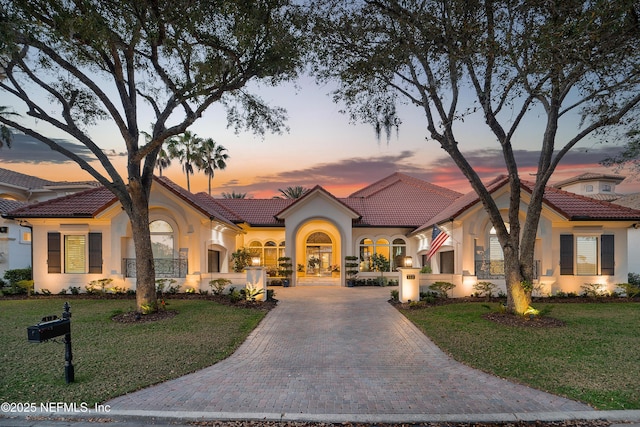 112 Harbourmaster Ct, Ponte Vedra Beach, FL 32082 - mediterranean / spanish home featuring stucco siding, a tile roof, driveway, and a front yard