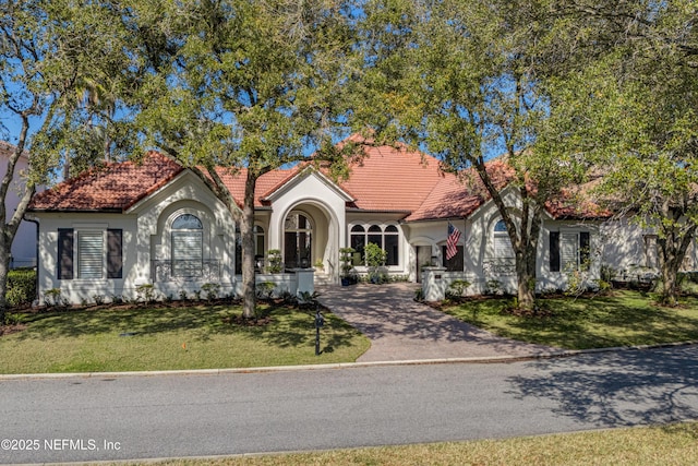 112 Harbourmaster Ct, Ponte Vedra Beach, FL 32082 - mediterranean / spanish house featuring a tile roof, stucco siding, driveway, and a front lawn