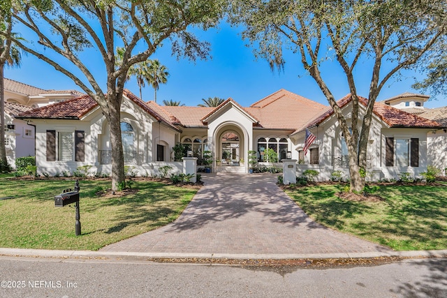 112 Harbourmaster Ct, Ponte Vedra Beach, FL 32082 - mediterranean / spanish house featuring a tiled roof, stucco siding, and a front lawn