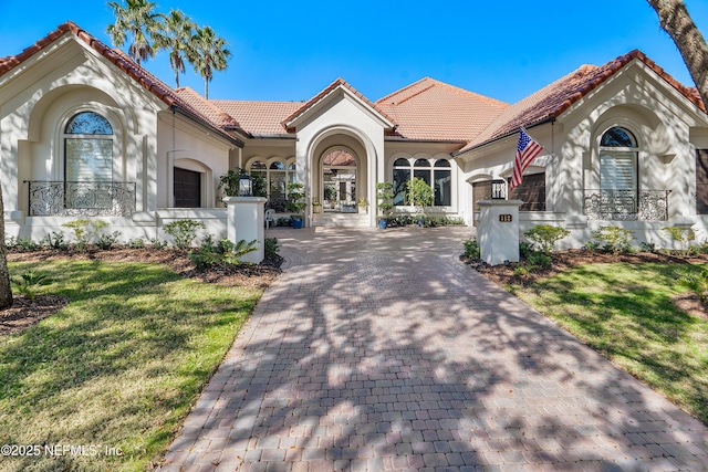 112 Harbourmaster Ct, Ponte Vedra Beach, FL 32082 - mediterranean / spanish house featuring a tiled roof, stucco siding, decorative driveway, and a front yard