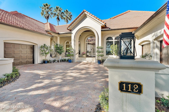 112 Harbourmaster Ct, Ponte Vedra Beach, FL 32082 - mediterranean / spanish home with a tiled roof, stucco siding, driveway, and a garage