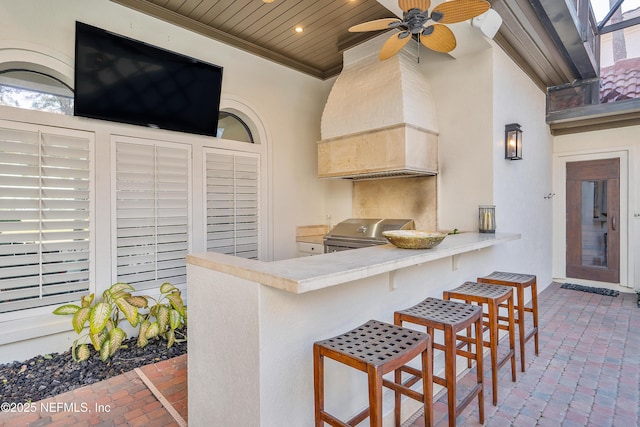 112 Harbourmaster Ct, Ponte Vedra Beach, FL 32082 - kitchen featuring brick floors, crown molding, ceiling fan, a kitchen breakfast bar, and recessed lighting