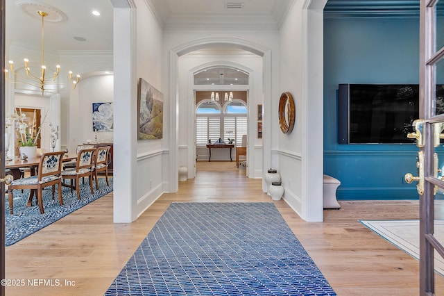 112 Harbourmaster Ct, Ponte Vedra Beach, FL 32082 - foyer with a chandelier, crown molding, light wood-type flooring, a decorative wall, and recessed lighting