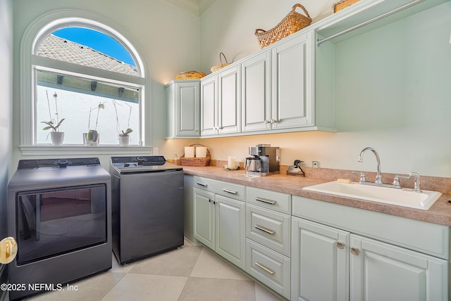 112 Harbourmaster Ct, Ponte Vedra Beach, FL 32082 - laundry room featuring washer and clothes dryer, cabinet space, crown molding, and light tile patterned floors