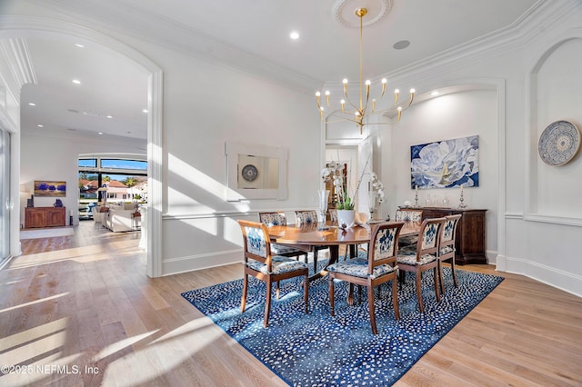 112 Harbourmaster Ct, Ponte Vedra Beach, FL 32082 - dining room with a chandelier, light wood finished floors, recessed lighting, arched walkways, and ornamental molding
