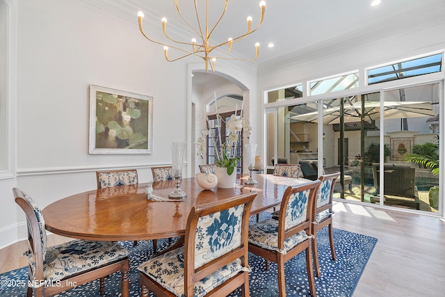 112 Harbourmaster Ct, Ponte Vedra Beach, FL 32082 - dining room with wood finished floors, ornamental molding, a chandelier, arched walkways, and recessed lighting