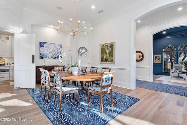 112 Harbourmaster Ct, Ponte Vedra Beach, FL 32082 - dining area with ornamental molding, a chandelier, light wood-style flooring, recessed lighting, and arched walkways