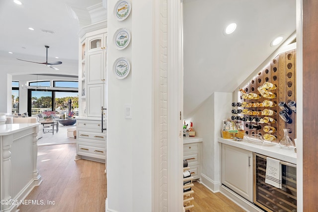 112 Harbourmaster Ct, Ponte Vedra Beach, FL 32082 - wine area with wine cooler, crown molding, ceiling fan, light wood-type flooring, and recessed lighting