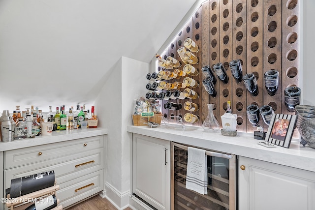 112 Harbourmaster Ct, Ponte Vedra Beach, FL 32082 - wine area with wine cooler, a bar, and light wood-style floors