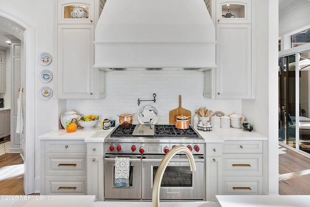 112 Harbourmaster Ct, Ponte Vedra Beach, FL 32082 - kitchen featuring premium range hood, double oven range, glass insert cabinets, and decorative backsplash