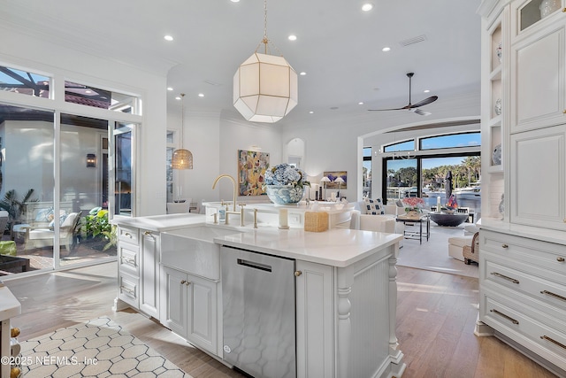 112 Harbourmaster Ct, Ponte Vedra Beach, FL 32082 - kitchen featuring stainless steel dishwasher, crown molding, white cabinets, open floor plan, and light countertops