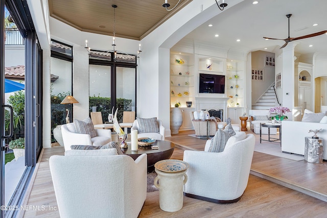 112 Harbourmaster Ct, Ponte Vedra Beach, FL 32082 - living area with plenty of natural light, ornamental molding, stairs, a fireplace, and a ceiling fan