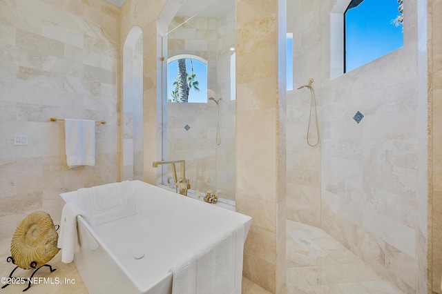 112 Harbourmaster Ct, Ponte Vedra Beach, FL 32082 - bathroom featuring tile walls, a freestanding tub, and walk in shower