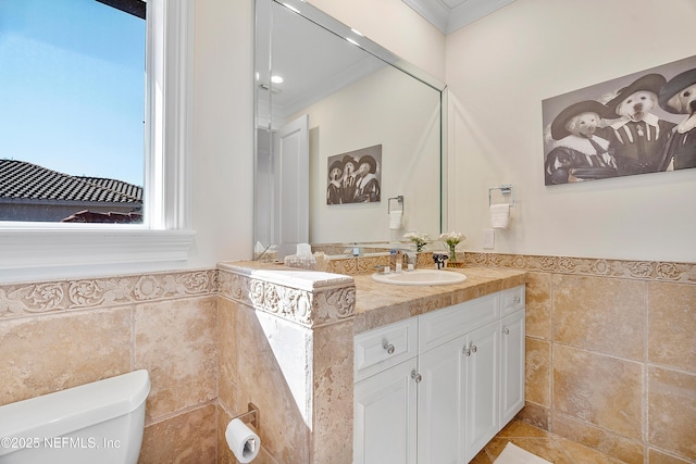 112 Harbourmaster Ct, Ponte Vedra Beach, FL 32082 - bathroom with tile walls, vanity, ornamental molding, a wainscoted wall, and tile patterned floors