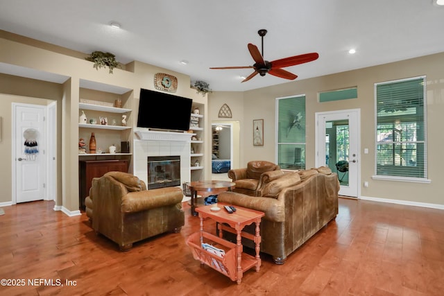 1685 Pinecrest Dr, Fleming Island, FL 32003 - living area featuring ceiling fan, a tile fireplace, built in shelves, light wood finished floors, and recessed lighting