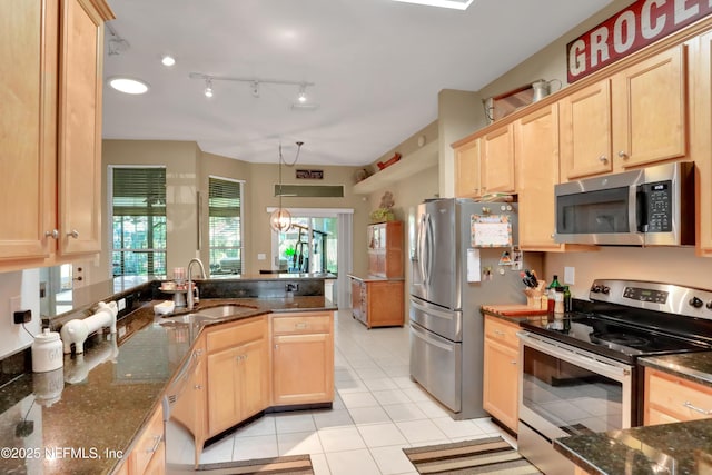 1685 Pinecrest Dr, Fleming Island, FL 32003 - kitchen featuring appliances with stainless steel finishes, light brown cabinets, dark stone countertops, and a peninsula