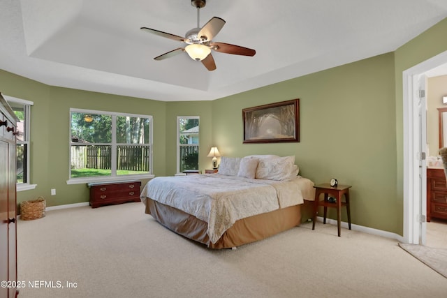 1685 Pinecrest Dr, Fleming Island, FL 32003 - carpeted bedroom with a raised ceiling, ensuite bathroom, and ceiling fan
