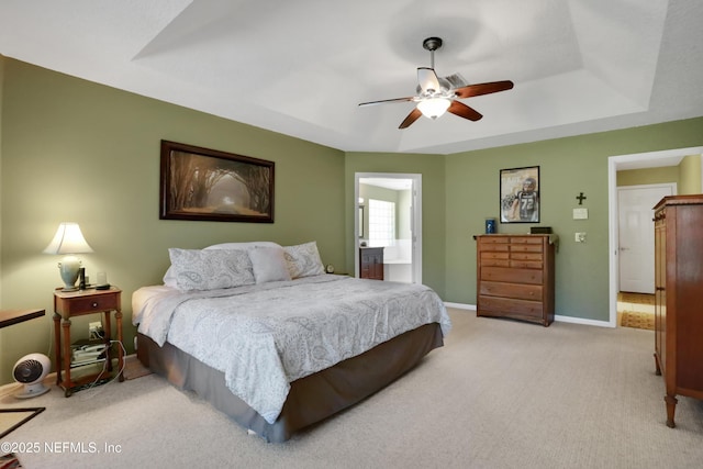 1685 Pinecrest Dr, Fleming Island, FL 32003 - bedroom with light colored carpet, a raised ceiling, a ceiling fan, and ensuite bath