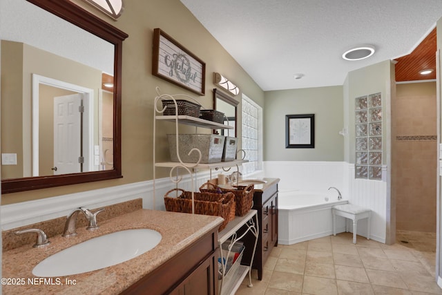 1685 Pinecrest Dr, Fleming Island, FL 32003 - bathroom with a wainscoted wall, a bath, vanity, a tile shower, and a textured ceiling