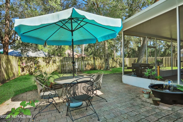 1685 Pinecrest Dr, Fleming Island, FL 32003 - fenced backyard with outdoor dining space, a patio, and a grill