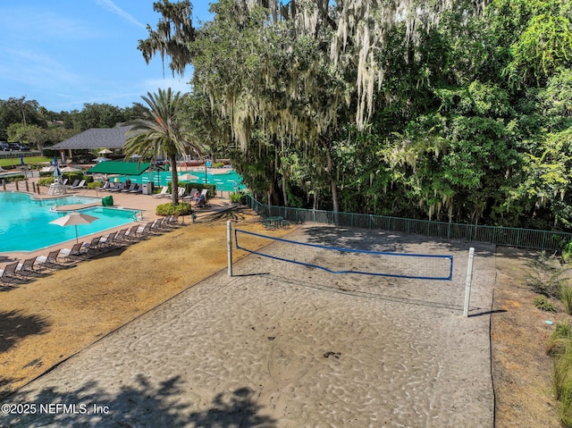 1685 Pinecrest Dr, Fleming Island, FL 32003 - view of community with a swimming pool, volleyball court, view of scattered trees, and a patio area