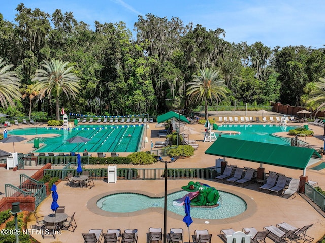 1685 Pinecrest Dr, Fleming Island, FL 32003 - community pool with view of wooded area, a water play area, and a patio