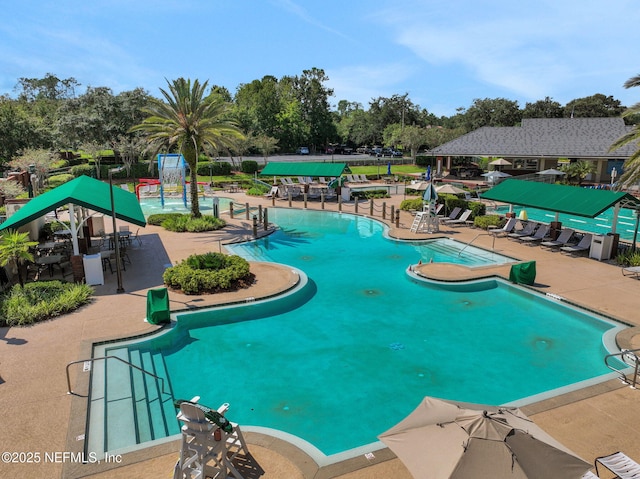 1685 Pinecrest Dr, Fleming Island, FL 32003 - community pool with a patio, view of wooded area, and a water play area