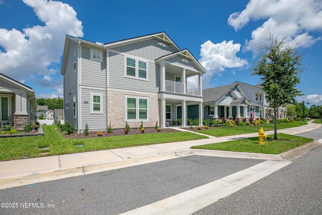 902 Orange Branch Trl, Saint Johns, FL 32259 - craftsman-style house featuring a balcony, board and batten siding, and a front yard