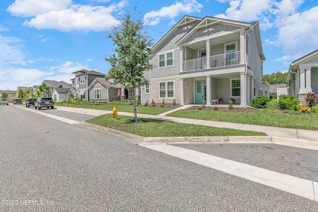 902 Orange Branch Trl, Saint Johns, FL 32259 - view of front of house featuring board and batten siding, a balcony, a residential view, a porch, and a front lawn