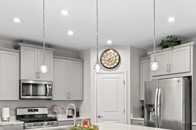 902 Orange Branch Trl, Saint Johns, FL 32259 - kitchen with appliances with stainless steel finishes, hanging light fixtures, recessed lighting, light stone counters, and gray cabinetry