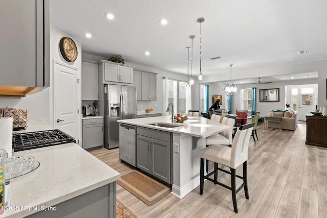 902 Orange Branch Trl, Saint Johns, FL 32259 - kitchen featuring gray cabinets, stainless steel appliances, open floor plan, a breakfast bar, and recessed lighting