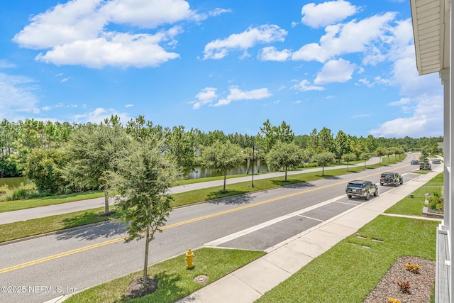 902 Orange Branch Trl, Saint Johns, FL 32259 - view of asphalt road featuring sidewalks, a water view, curbs, and view of scattered trees