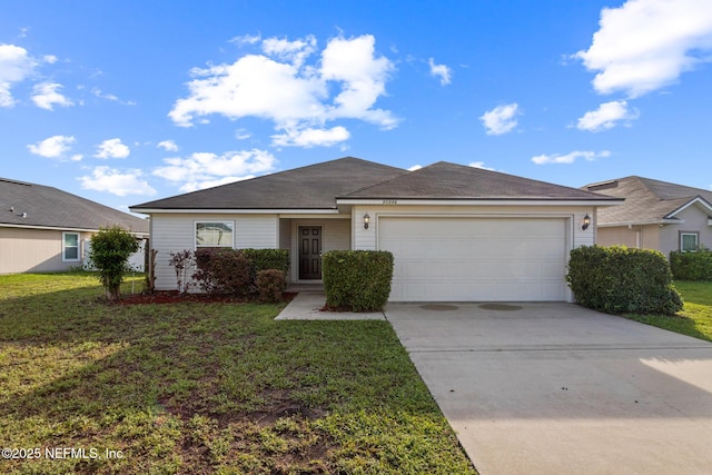 95886 Graylon Dr, Yulee, FL 32097 - ranch-style house with driveway, an attached garage, and a front lawn