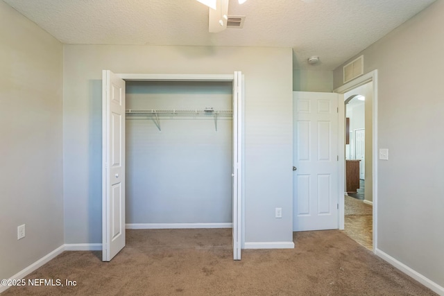 95886 Graylon Dr, Yulee, FL 32097 - unfurnished bedroom with carpet, a closet, a textured ceiling, and arched walkways