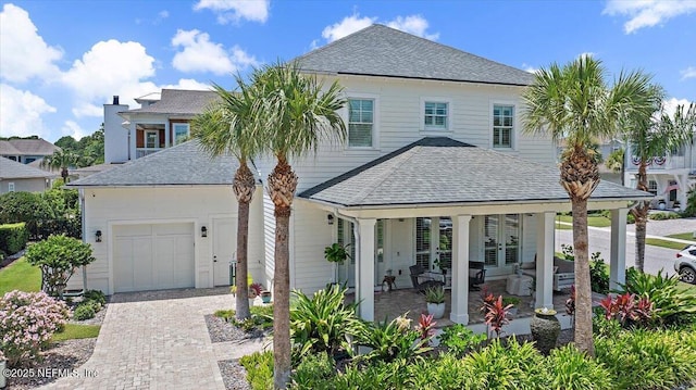 1639 Maritime Oak Dr, Atlantic Beach, FL 32233 - view of front of property featuring a shingled roof, french doors, decorative driveway, a garage, and covered porch