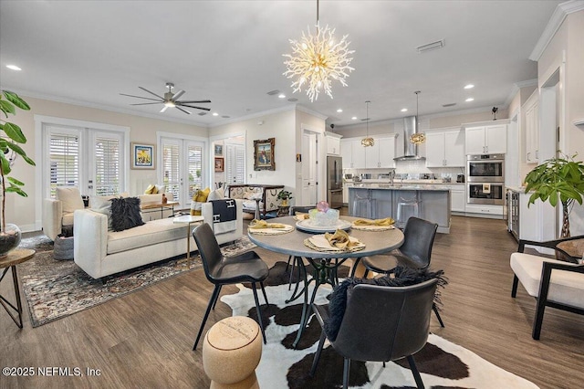 1639 Maritime Oak Dr, Atlantic Beach, FL 32233 - dining area with dark wood-style floors, ornamental molding, a ceiling fan, recessed lighting, and a chandelier