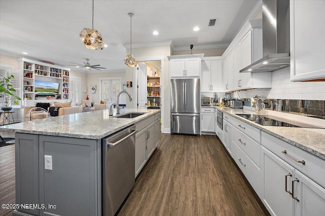 1639 Maritime Oak Dr, Atlantic Beach, FL 32233 - kitchen with a ceiling fan, wall chimney range hood, dark wood finished floors, stainless steel appliances, and white cabinets
