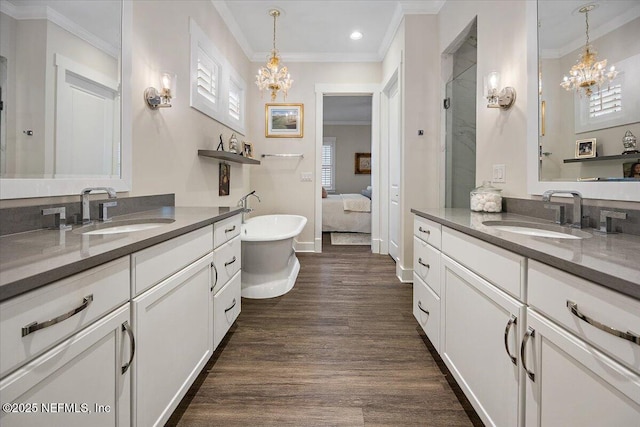1639 Maritime Oak Dr, Atlantic Beach, FL 32233 - full bathroom featuring a chandelier, wood finished floors, ornamental molding, two vanities, and recessed lighting