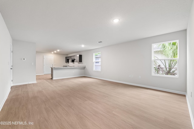 8077 Devoe St, Jacksonville, FL 32220 - unfurnished living room with light wood-style flooring and recessed lighting