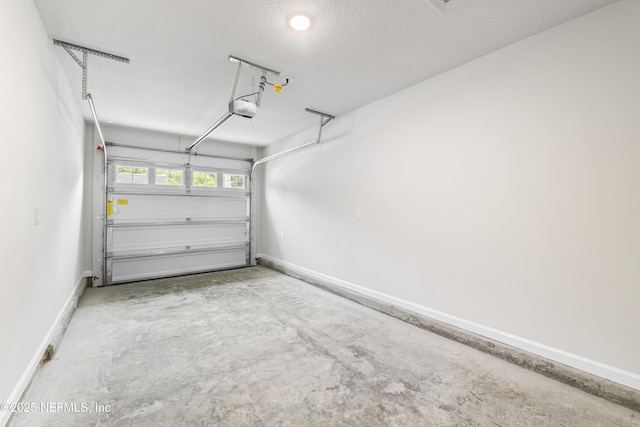 8077 Devoe St, Jacksonville, FL 32220 - garage featuring a garage door opener and baseboards