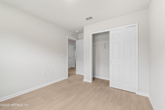8077 Devoe St, Jacksonville, FL 32220 - unfurnished bedroom with light wood-style floors and a closet